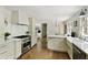 Bright kitchen features stainless steel appliances, white cabinetry, and wood floors at 2973 Payton Ne Rd, Atlanta, GA 30345