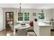 Bright eat-in kitchen features a breakfast nook, a round table, and white cabinetry at 2973 Payton Ne Rd, Atlanta, GA 30345