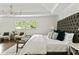 Stylish main bedroom featuring an oversized headboard, tray ceiling and large windows at 2973 Payton Ne Rd, Atlanta, GA 30345