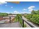 Balcony with metal railing offering a scenic view of mature trees and the surrounding neighborhood at 326 Roswell Se St # 406, Marietta, GA 30060