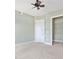 Comfortable bedroom features a ceiling fan, closet space, and neutral carpet and paint at 326 Roswell Se St # 406, Marietta, GA 30060
