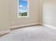 Bright bedroom with a window view and plush carpeting is a neutral space at 326 Roswell Se St # 406, Marietta, GA 30060