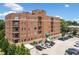 Exterior view of the brick condominium building featuring private balconies and convenient parking at 326 Roswell Se St # 406, Marietta, GA 30060