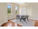 Dining room with a table and seating for four, large windows, and hardwood floors at 326 Roswell Se St # 406, Marietta, GA 30060