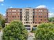 Exterior view of an apartment complex with a central entrance and landscaping at 326 Roswell Se St # 406, Marietta, GA 30060