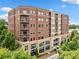 Exterior view of a brick apartment complex with balconies and landscaping at 326 Roswell Se St # 406, Marietta, GA 30060