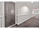 Well-lit condo hallway with neutral gray walls and carpeting leading to unit 406 at 326 Roswell Se St # 406, Marietta, GA 30060