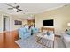 Open-concept living room area showing hardwood floors, TV, with view of the kitchen at 326 Roswell Se St # 406, Marietta, GA 30060