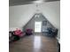 Attic features a high ceiling with red sofas and a large window at 3560 Elinburg Dr, Buford, GA 30519