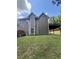 Spacious backyard with trees, and a covered carport area at 3560 Elinburg Dr, Buford, GA 30519