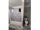 This bathroom has a shower with a blue patterned shower curtain at 3560 Elinburg Dr, Buford, GA 30519