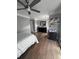 Bright bedroom with a ceiling fan, wood floors, and a large dresser at 3560 Elinburg Dr, Buford, GA 30519
