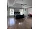 Bedroom featuring wood floors, ceiling fan, and dark grey bed with matching pillows at 3560 Elinburg Dr, Buford, GA 30519