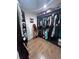 Organized walk-in closet with dark wood cabinetry and ample storage space at 3560 Elinburg Dr, Buford, GA 30519