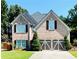 Charming two-story brick home with a well-manicured lawn, two-car garage, and meticulous landscaping at 3560 Elinburg Dr, Buford, GA 30519