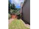 Home exterior featuring manicured lawn and garden, wood fence, and mature tree at 3560 Elinburg Dr, Buford, GA 30519