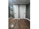 The home features a beautiful hallway with wood floors and closet doors at 3560 Elinburg Dr, Buford, GA 30519