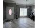 Inviting living room featuring tiled floors, a decorative chandelier and a view of the front yard at 3560 Elinburg Dr, Buford, GA 30519