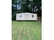 Outbuilding with windows and a door in a green backyard at 3560 Elinburg Dr, Buford, GA 30519