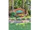 Community sign featuring brick pillars, lush landscaping, and green and gold lettering at 3560 Elinburg Dr, Buford, GA 30519