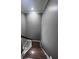 Classic staircase with wooden steps, white railings, and neutral walls leading to the upper level of the home at 3560 Elinburg Dr, Buford, GA 30519