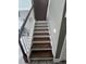 Elegant staircase features wooden steps, white risers, and a combination of white and wooden railing at 3560 Elinburg Dr, Buford, GA 30519