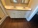 Bathroom vanity with double sinks, white cabinets and wood-style flooring at 4189 Duncan Ives Dr, Buford, GA 30519