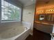 Bathroom featuring a tub, tiled backsplash, and windows for natural light at 4189 Duncan Ives Dr, Buford, GA 30519