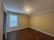 Bedroom with wood-style flooring, neutral walls and window at 4189 Duncan Ives Dr, Buford, GA 30519
