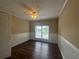 Bedroom with wood-style flooring, wainscotting and window at 4189 Duncan Ives Dr, Buford, GA 30519