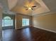 Spacious bedroom with tray ceiling, hardwood floors, and abundant natural light from multiple windows at 4189 Duncan Ives Dr, Buford, GA 30519