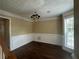 Elegant dining room features hardwood floors, decorative trim, and a stylish chandelier at 4189 Duncan Ives Dr, Buford, GA 30519