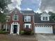 Charming two-story brick home with manicured landscaping and attached two car garage at 4189 Duncan Ives Dr, Buford, GA 30519