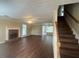 Spacious living room boasts a brick fireplace, hardwood floors, and plenty of natural light at 4189 Duncan Ives Dr, Buford, GA 30519