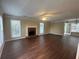 Bright living room with hardwood floors, fireplace, and large windows, perfect for entertaining at 4189 Duncan Ives Dr, Buford, GA 30519
