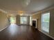 Inviting living room featuring hardwood floors, a fireplace, and ample natural light from large windows at 4189 Duncan Ives Dr, Buford, GA 30519