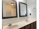 Bathroom featuring a double vanity, updated mirrors, and neutral walls at 795 Abbotts Mill Ct # 73, Johns Creek, GA 30097