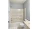 Full bathroom with a white tiled shower and a toilet next to a vanity sink at 795 Abbotts Mill Ct # 73, Johns Creek, GA 30097