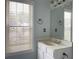 Bathroom featuring a vanity, sink, mirror, window, and dark fixtures at 795 Abbotts Mill Ct # 73, Johns Creek, GA 30097