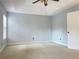 Bedroom features neutral walls, carpet, and a bright ceiling fan fixture at 795 Abbotts Mill Ct # 73, Johns Creek, GA 30097