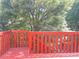 Red wooden deck with trees in the background at 795 Abbotts Mill Ct # 73, Johns Creek, GA 30097