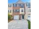 Two-story townhouse with brick facade, a driveway, attached garage and well-kept front yard at 795 Abbotts Mill Ct # 73, Johns Creek, GA 30097