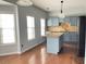 Bright, open kitchen with hardwood floors, stainless steel appliances, and granite countertops at 795 Abbotts Mill Ct # 73, Johns Creek, GA 30097