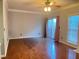 Empty living room with hardwood floors, neutral walls, and a sliding glass door to the outside at 795 Abbotts Mill Ct # 73, Johns Creek, GA 30097