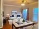 Staged living room featuring contemporary furniture, a white couch, and a dining table with chairs at 795 Abbotts Mill Ct # 73, Johns Creek, GA 30097