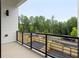 Modern balcony with black metal railings and views of surrounding trees at 11560 Serenbe Ln, Chattahoochee Hills, GA 30268