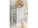 Beautiful bathroom showcasing walk-in closet, vanity, sconces and a designer light fixture at 11560 Serenbe Ln, Chattahoochee Hills, GA 30268