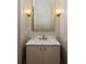 A clean bathroom with marble countertops, a stylish sink, and gold fixtures at 11560 Serenbe Ln, Chattahoochee Hills, GA 30268