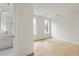 Bright bedroom with hardwood floors and a view into a stylish bathroom at 11560 Serenbe Ln, Chattahoochee Hills, GA 30268