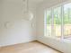 Bedroom with hardwood floors, natural light from large windows with views to the outdoors at 11560 Serenbe Ln, Chattahoochee Hills, GA 30268